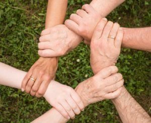 people locking their hands together